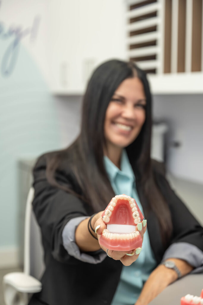 smarter orthodontics nurse holding a model of a mouth with invisalign